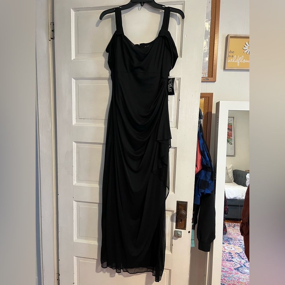 NWT black formal dress w/ some sheer swing side overlay on chest. Zip closure